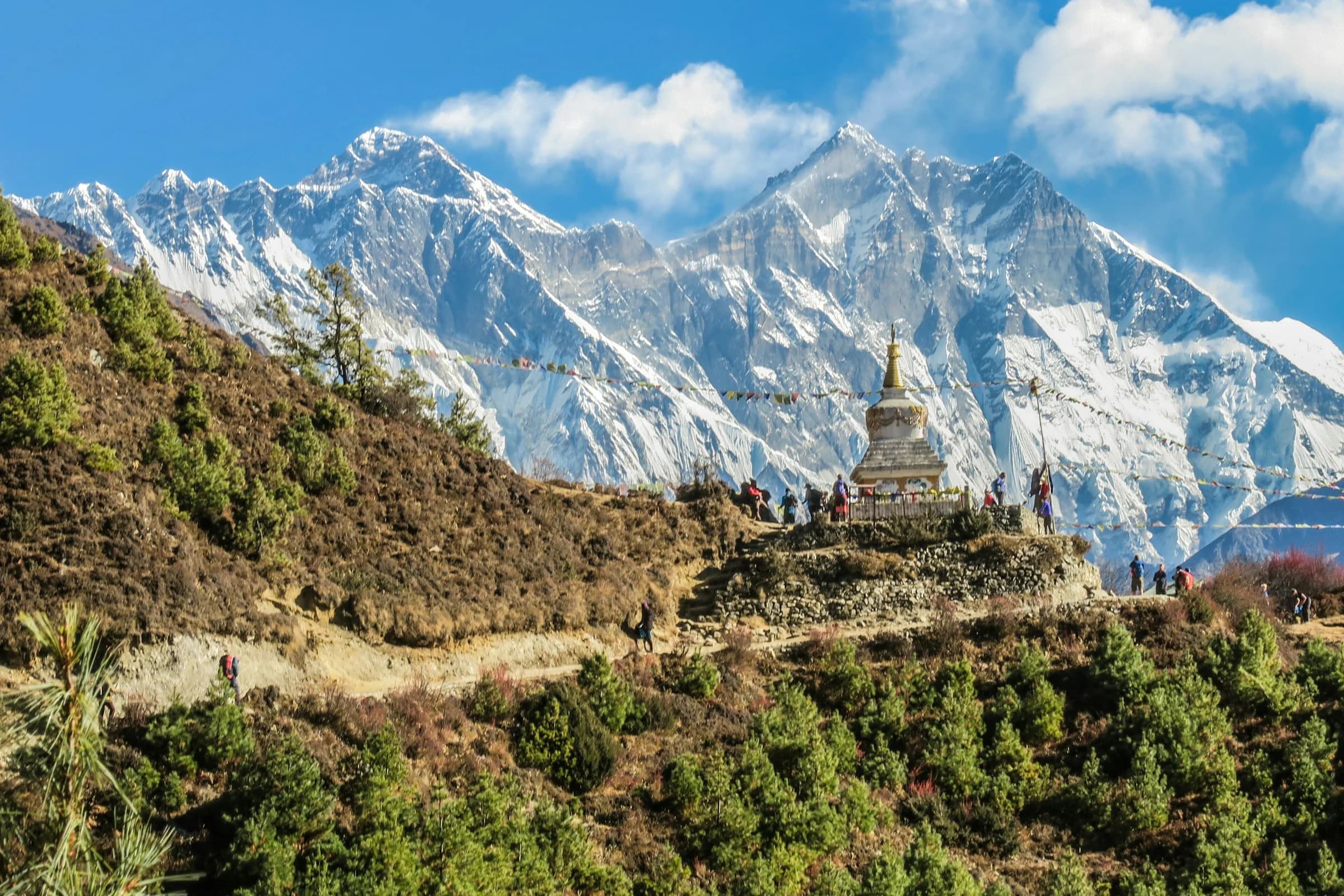 Nepal — Himalayan peaks and Buddhist stupa with prayer flags